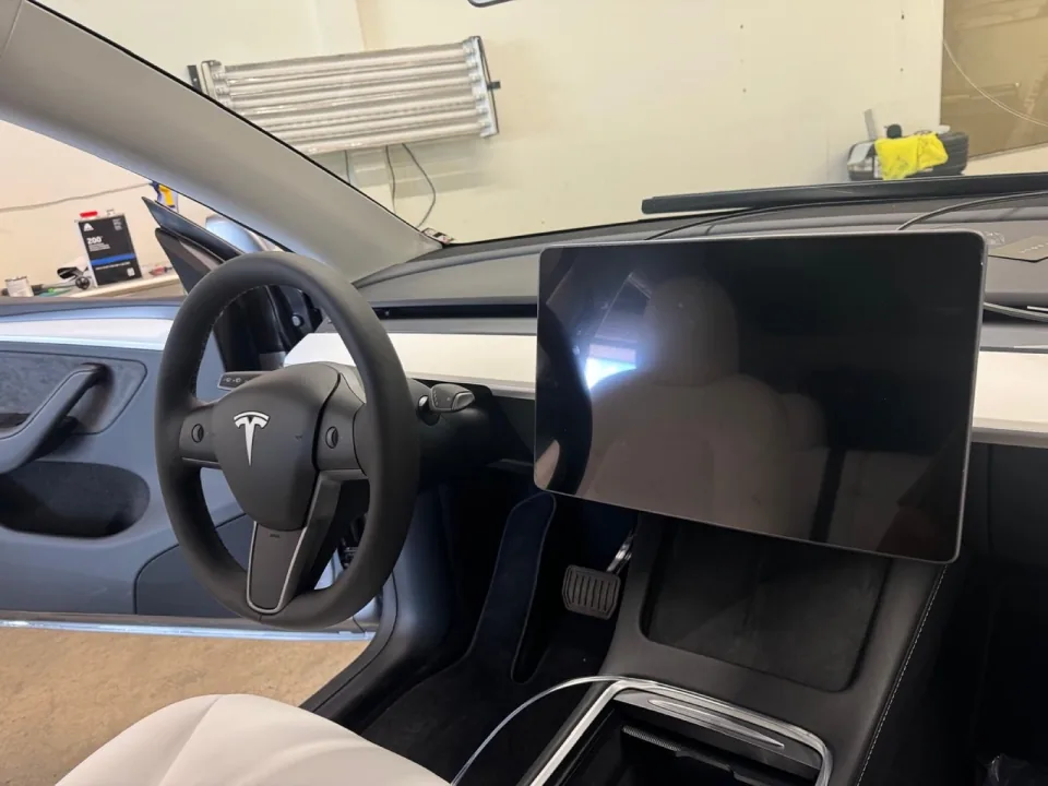 A 2025 Tesla Model Y interior during an in-dash LED lighting install at Conexion